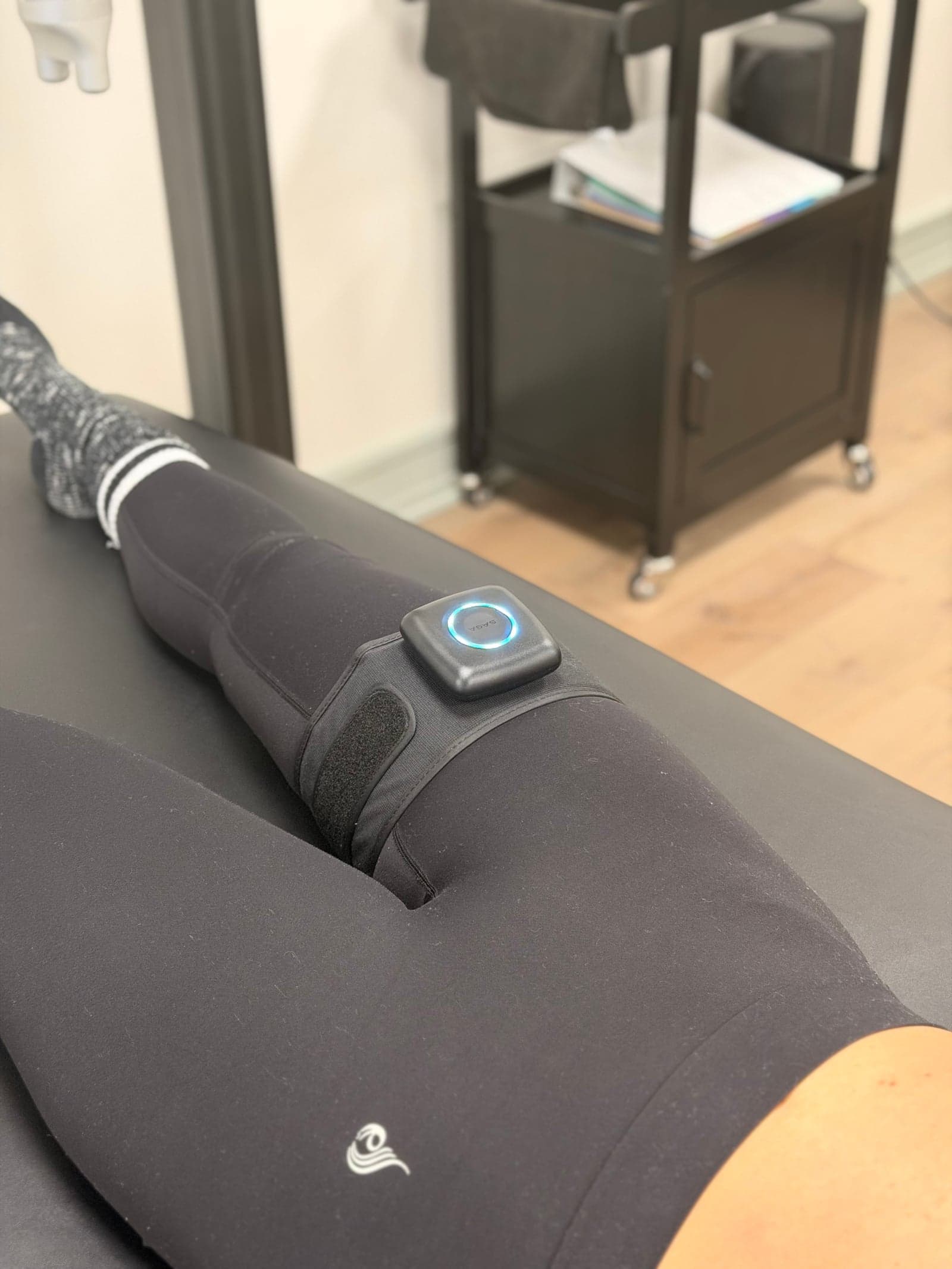 SAGA blood flow restriction cuff on a patient's upper thigh during clinical rehab at Thera Performance Lab in Lake Orion, Michigan
